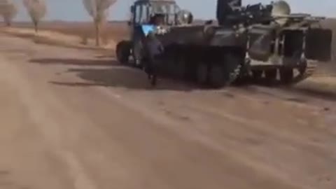 Ukrainian farmer using his tractor to stole a Tank