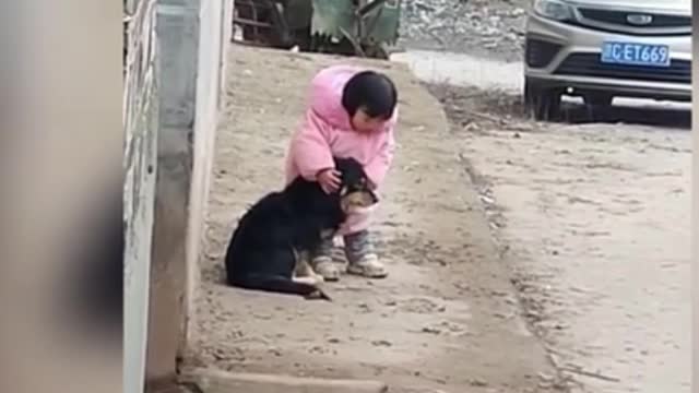 The little girl covered her dog's ears when there was a firecracker.. the action says it all