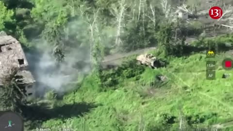 A drone shows Ukrainian soldiers attacking an armored vehicle