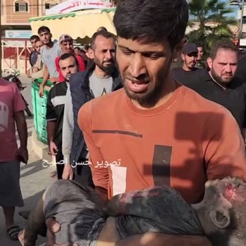 Palestinian Man Holds His Dead Child