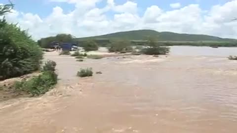 Lucky individuals saved by the helicopter from the flooding river submerging there truck