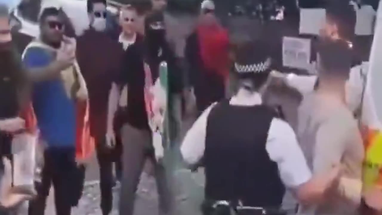 Subject in custody of UK police assaulted by crowd.