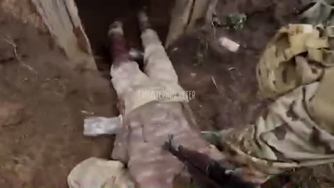 Russian soldiers clear out a Ukrainian dugout. Ukrainian soldier surrender and crawl out.