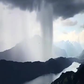 The sky has broken over Lake Hallstetter in Austria