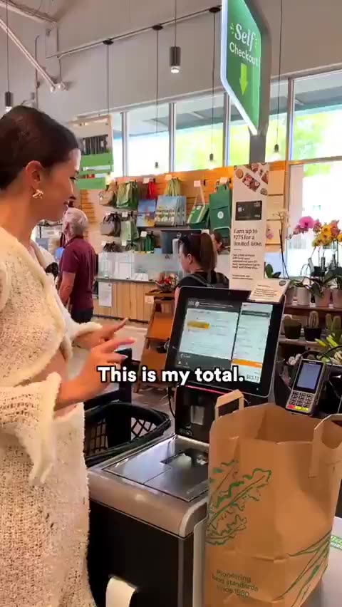 Digital ID in California. Paying for groceries with her palm.