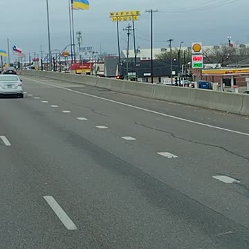 Ukrainian flags flying next to American flags in Dallas Texas