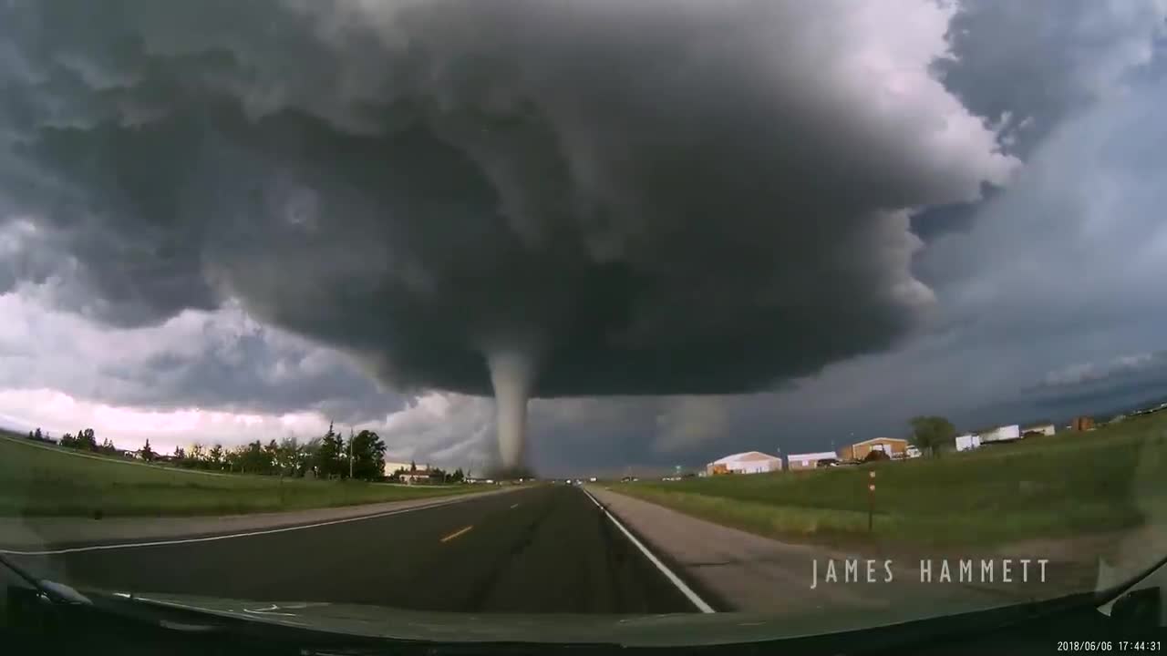 Storm chasing dashcam: Tornado crossing the highway! Laramie, Wyoming