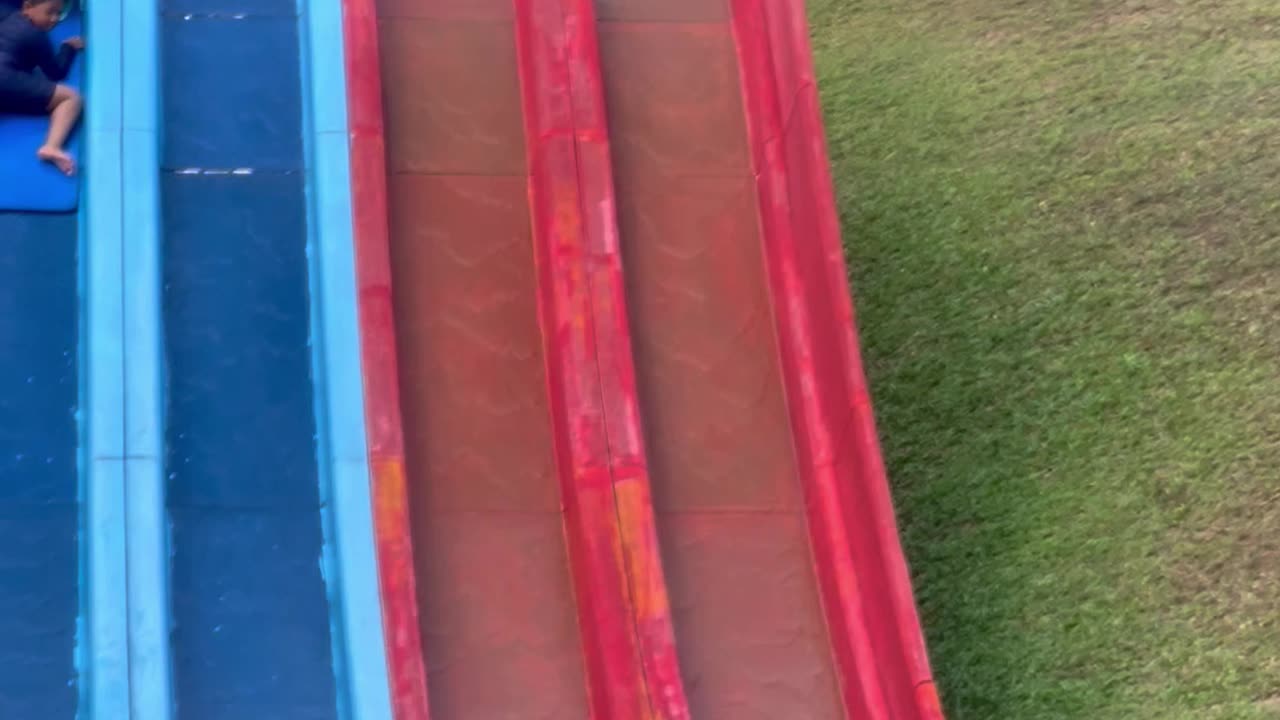 Guy Helps Boy Stuck in the Middle of Water Slide