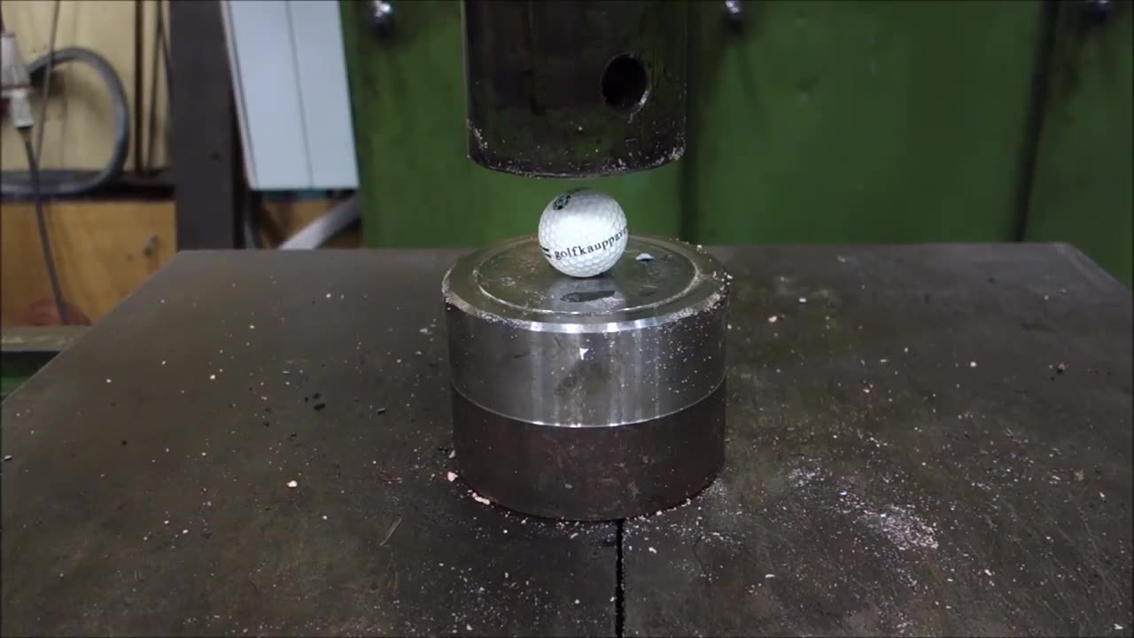 Crushing golf ball with hydraulic press