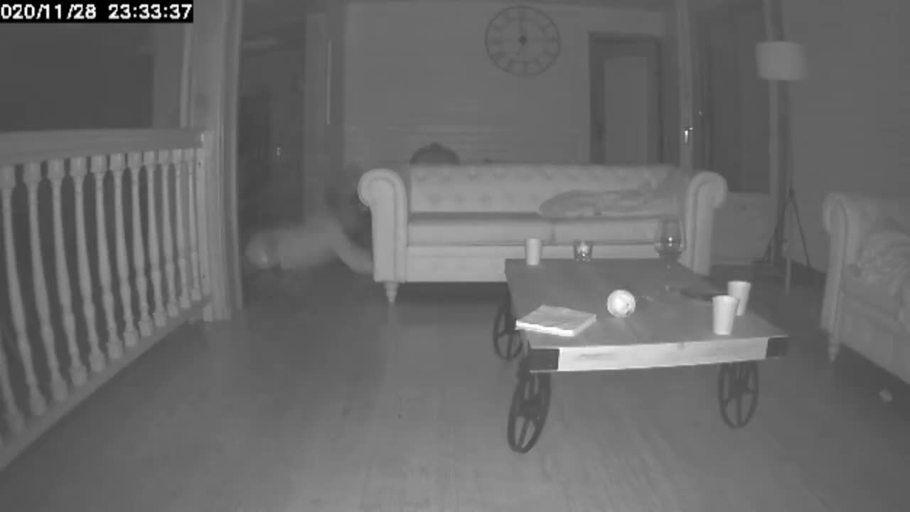 Surveillance Camera Records A Man Falling Down When He Walks Around The House At Night