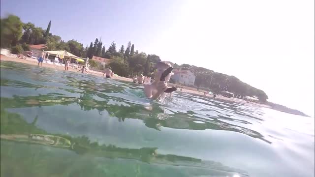 Dad And Kid Throw Sea Cucumbers At Each Other After Kid Swims Underwate