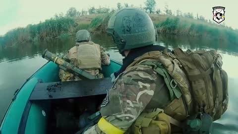 Ukrainian forces make a river crossing in a small boat