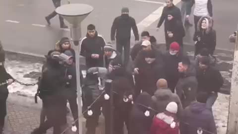 Policeman losing his weapon to protestors Kazakhstan