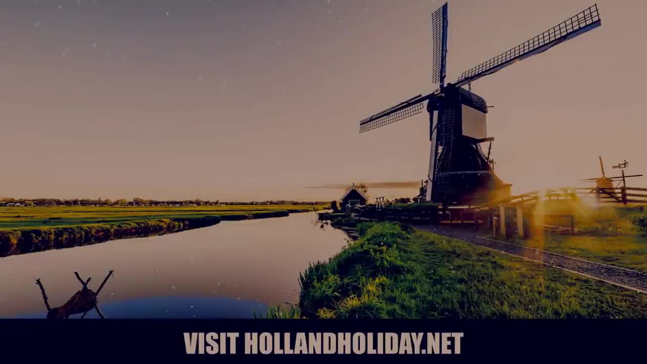 Dutch windmill in foggy landscape at sunrise filmed with a DRONE