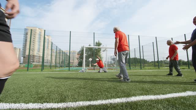 a group of elderly men playing a soccer game