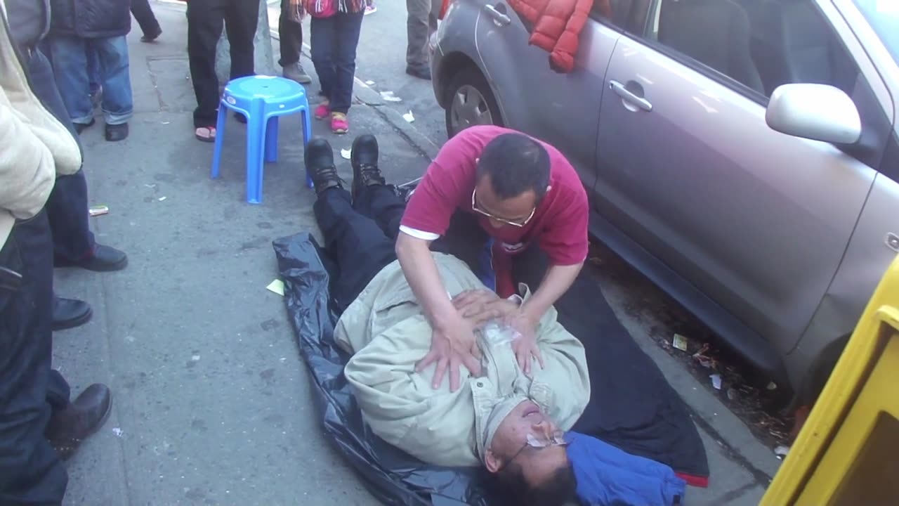 Luodong Briefly Massages Elderly Chinese Man In Gray Coat On Sidewalk