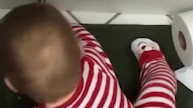 cute baby laughs when he sees his toy moving