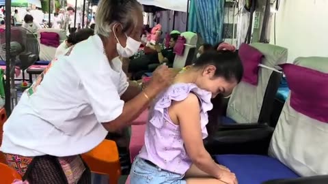 Thai street massage, open-air granny massage, $4 a session, 60 years of experience