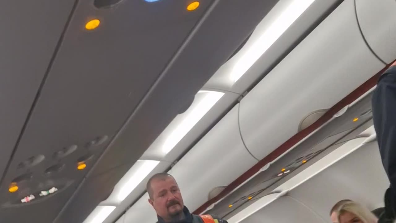 Airplane Passengers Cheer For Police During Arrest