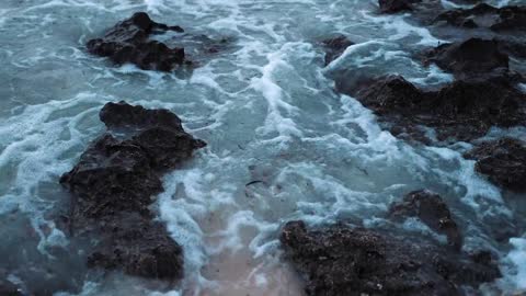 Close-Up Of Waves Breaking In The Rocks