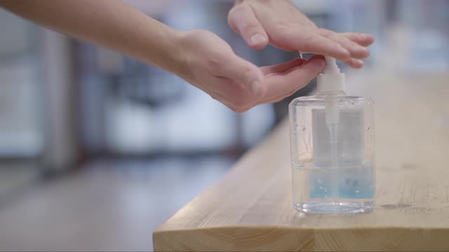 Close up of Male Cleaning Hands Using Hand Sanitiser
