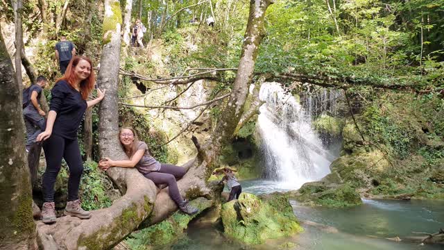 This girl is enjoying herself near the waterfall