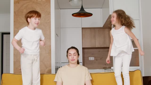 Look mama is teaching yoga to her children