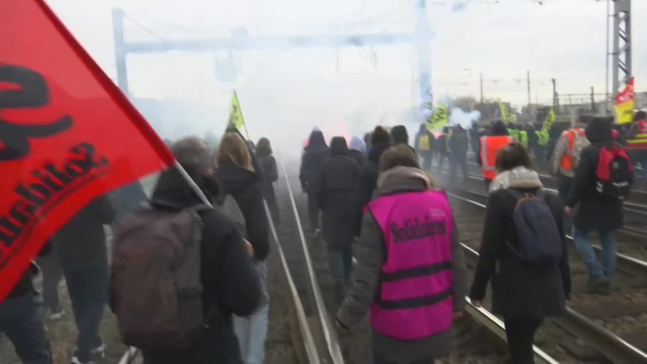 Anti-pension reform protesters walk on the tracks of the Paris train station Gare de Lyon