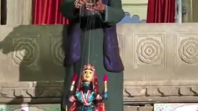 Man Entertains Crowd With Puppet Dance