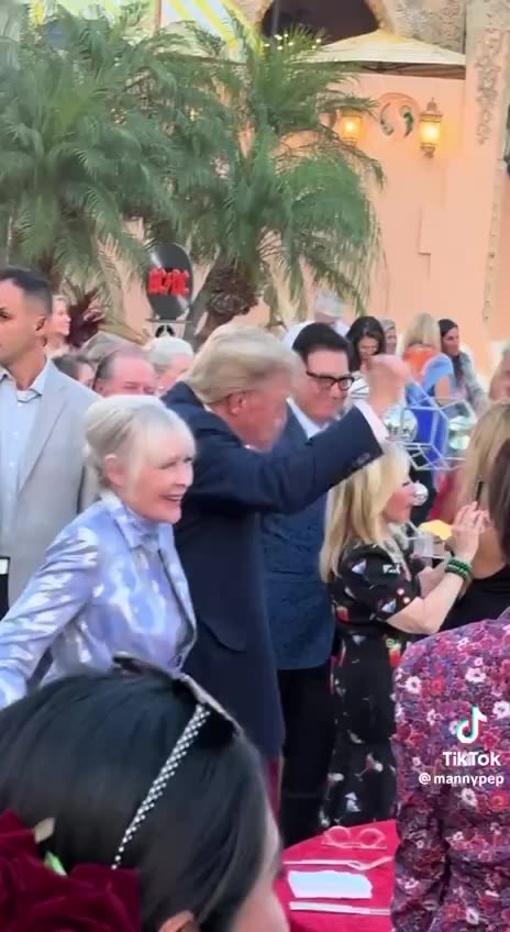 Trump watches as a Village People band rocks out at Mar-a-Lago