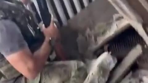 Russian soldier shooting down a Ukrainian drone with a shotgun and radio sensor