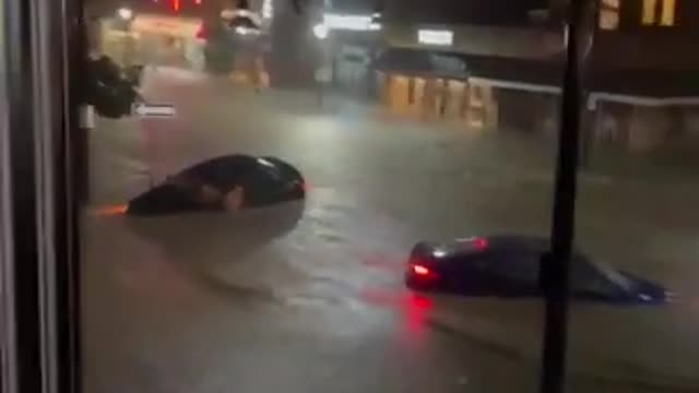 People Stuck In Bar Witness Cars Stranded In Middle Of Flooded Streets During Heavy Rain