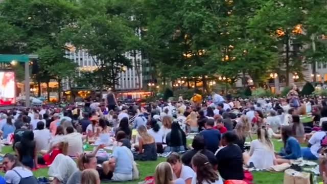 Movies in the open air are crowded with people.