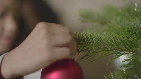 CU Childs Hands Decorating Christmas Tree 1