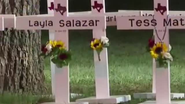 21 crosses stand in front of Robb Elementary School in Uvalde, Texas