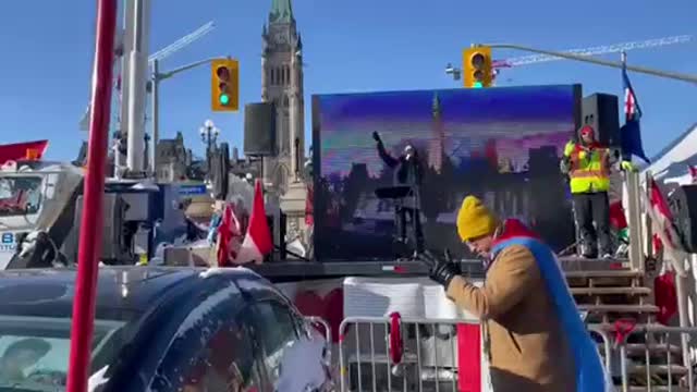 While police are arresting Freedom Convoy trucker, freedom persists one block away