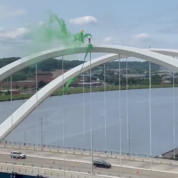 Man protesting Supreme Court decision on abortion at the top of the Frederick Douglass Bridge