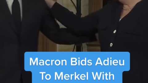 Macron Bids AdieuTo Merkel WithHug And Award