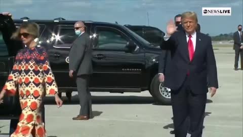 Donald Trump walks down the stairs at Palm Beach Airport and gets into an armored SUV