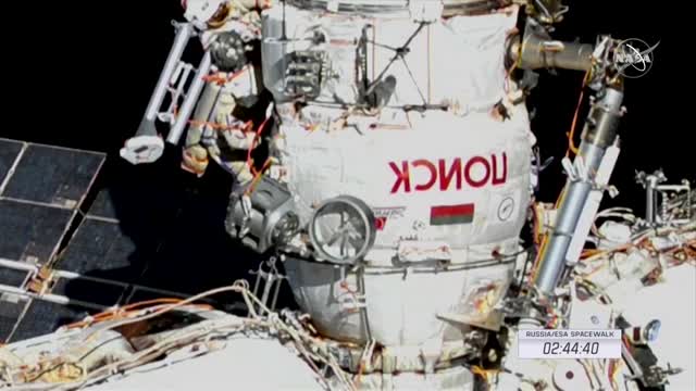 ISS crew members work on new robotic arm