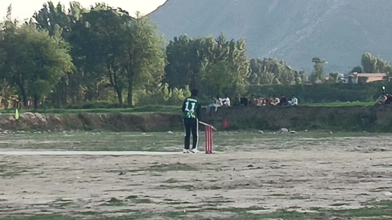 A Pakistani street cricket.A huge six by right handed batsman .