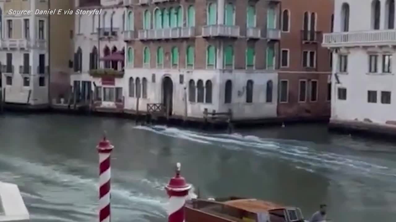 Daredevils ride electric surfboards through Venice canals