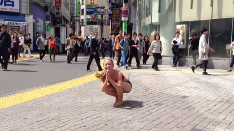 Yoga at Shibuya Crossing, Tokyo Japan: Pinchamayurasana