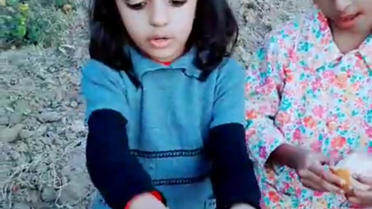 Kids eating Orange in field