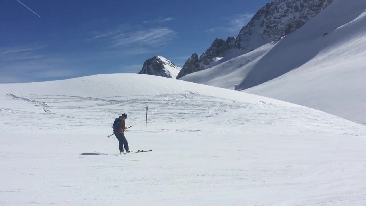 Skier Takes Off One Of His Skis, Flips It And Balances It On His Foot While Smoothly Going On Snow