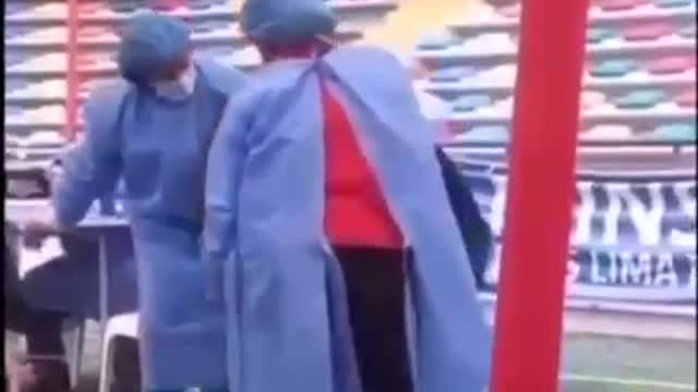 China - Farther holding his son down from escaping the vaccination shot