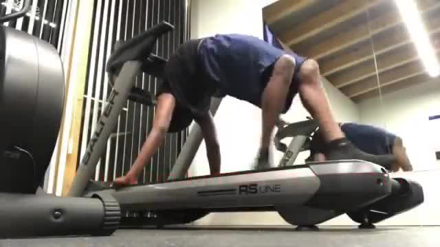 Guy Walks On Treadmill Using His Hands While Turning His Upper Body Back To Touch Down