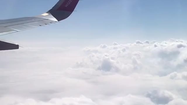 happy flying above the clouds