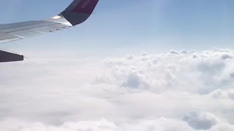 happy flying above the clouds