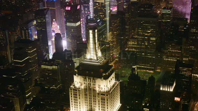 A city tower illuminates the night sky